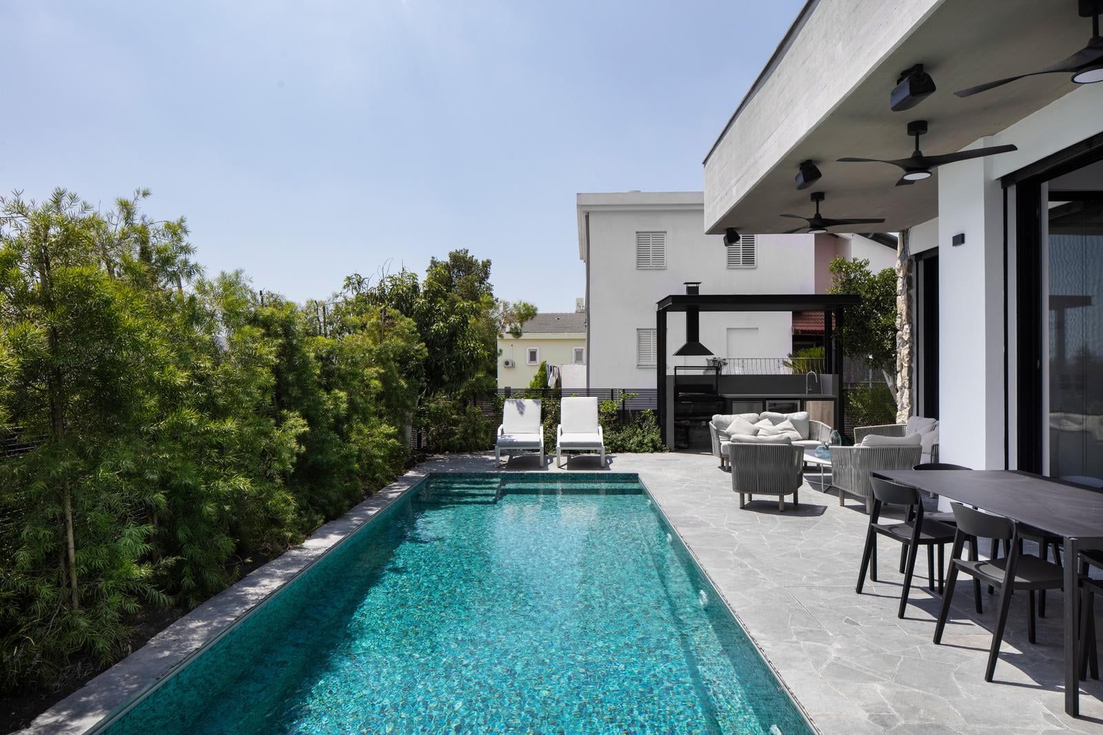 Private pool edged by a stone terrace and sun loungers