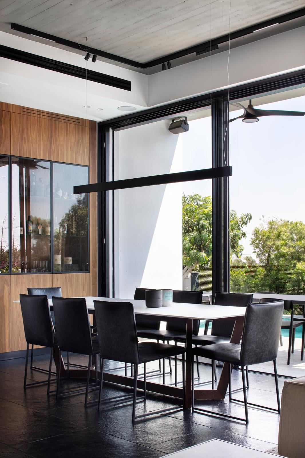 Dining area opening onto the garden through large glass doors